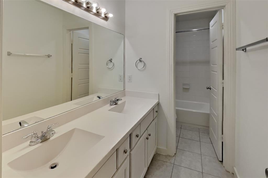 1538 Calcot Lane Forney, TX 75126 - Photo 16 of 21 a bathroom with a tub sink double vanity and a mirror