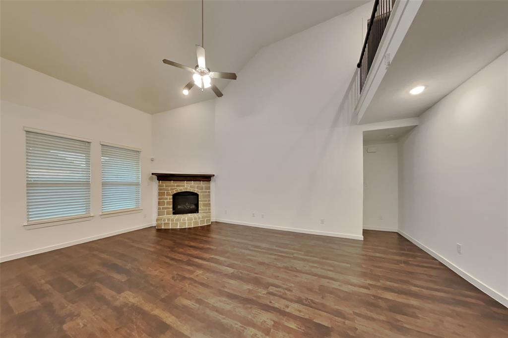 1538 Calcot Lane Forney, TX 75126 - Photo 2 of 21 an empty room with wooden floor fan and windows