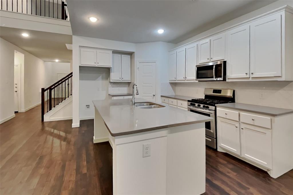 1538 Calcot Lane Forney, TX 75126 - Photo 3 of 21 a kitchen with stainless steel appliances kitchen island granite countertop a sink a stove and cabinets