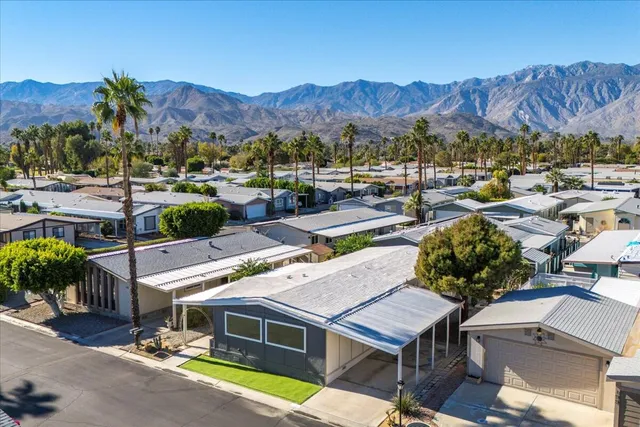 a view of a house with a swimming pool and a yard
