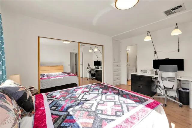 a view of a patio with table and chairs and floor to ceiling window