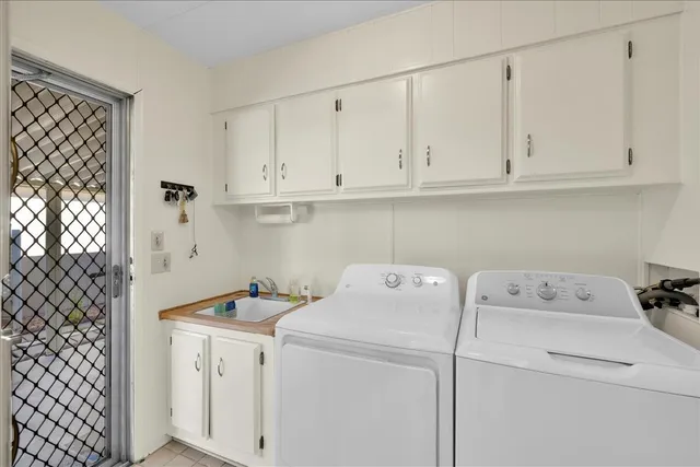 a view of backyard with swimming pool and green space