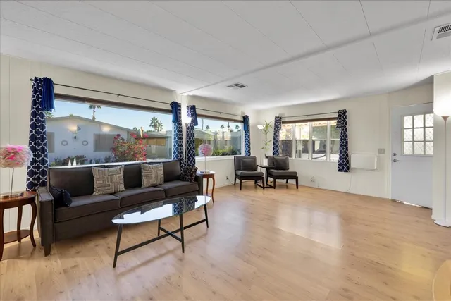 a kitchen with stainless steel appliances granite countertop a refrigerator a stove and a sink with island