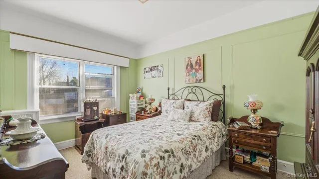 a bedroom with a bed and a large window with outer view