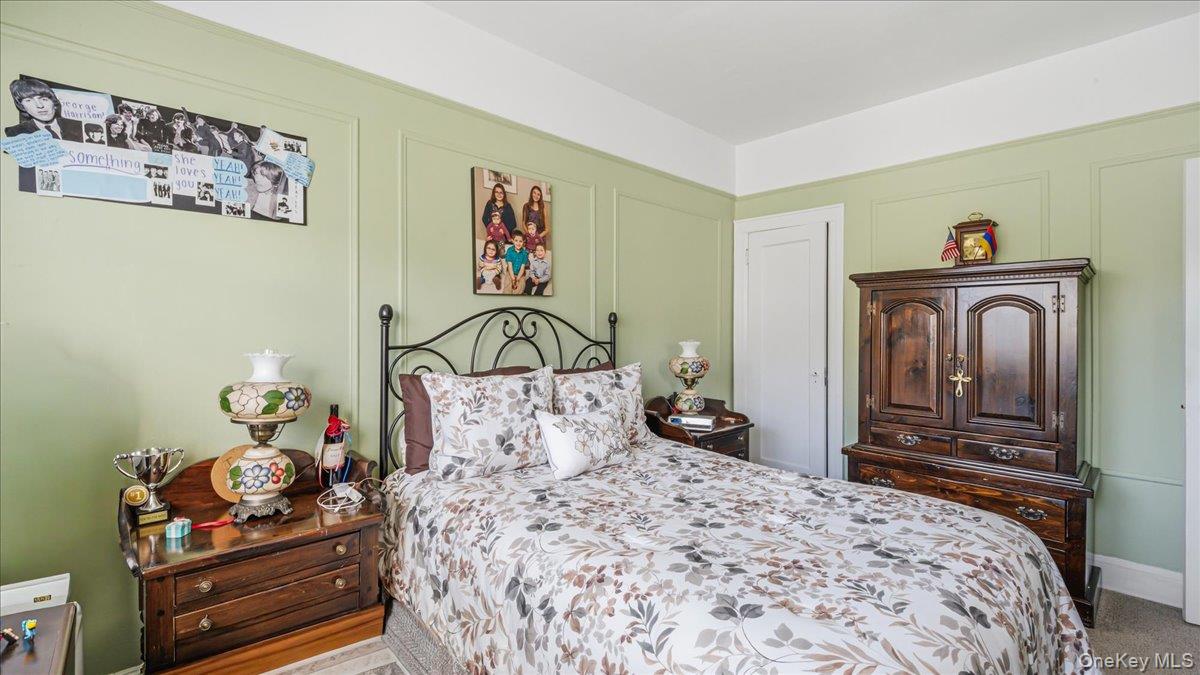 52-61 66th Street Queens, NY 11378 - Photo 13 of 26 a bedroom with a bed and wooden floor