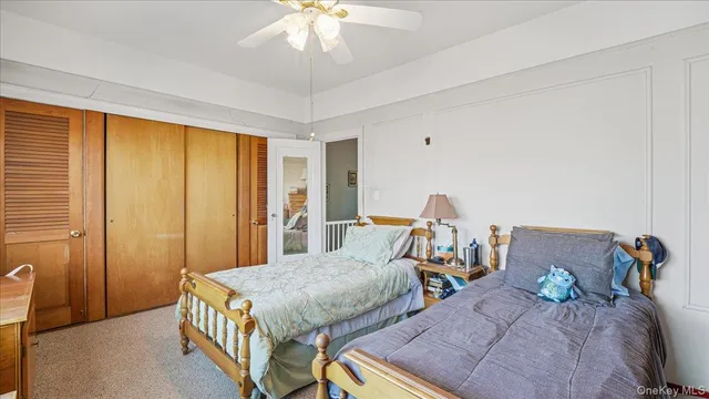 a bedroom with two beds and a chandelier