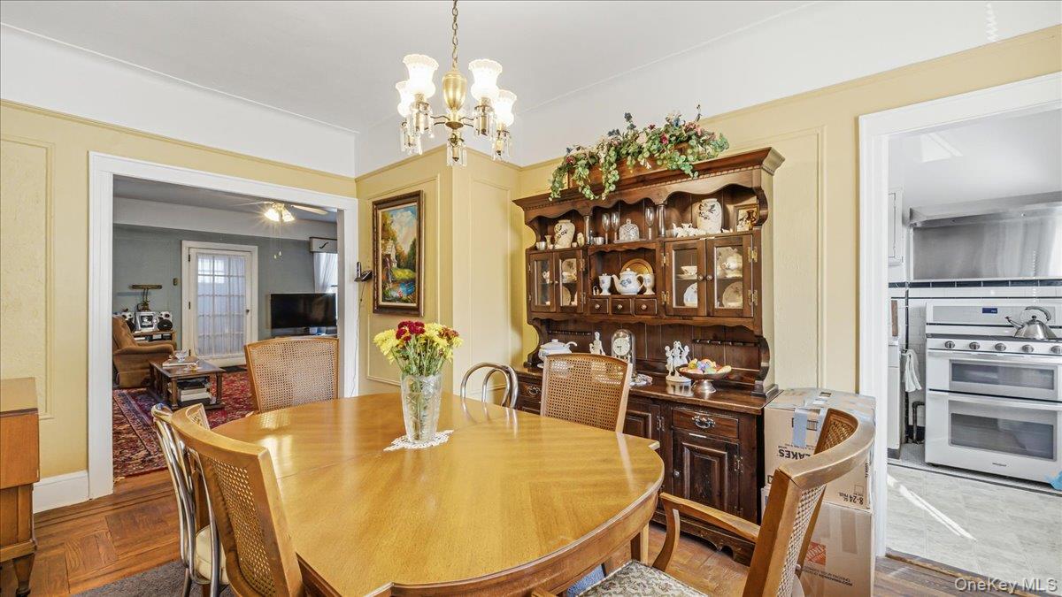 52-61 66th Street Queens, NY 11378 - Photo 5 of 26 a dining room with furniture a chandelier and wooden floor