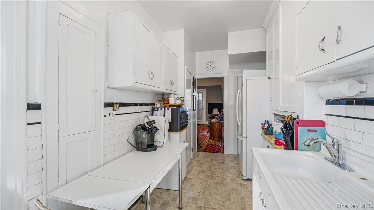 52-61 66th Street Queens, NY 11378 - Photo 7 of 26 a view of walk in closet with clothes and shoes