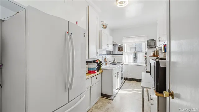 a very nice looking open kitchen with stainless steel appliances