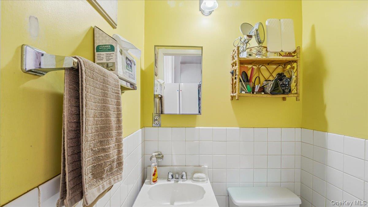 52-61 66th Street Queens, NY 11378 - Photo 9 of 26 a bathroom with a sink and mirror