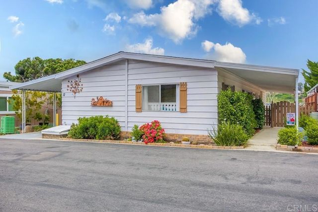a front view of house with garage and garden