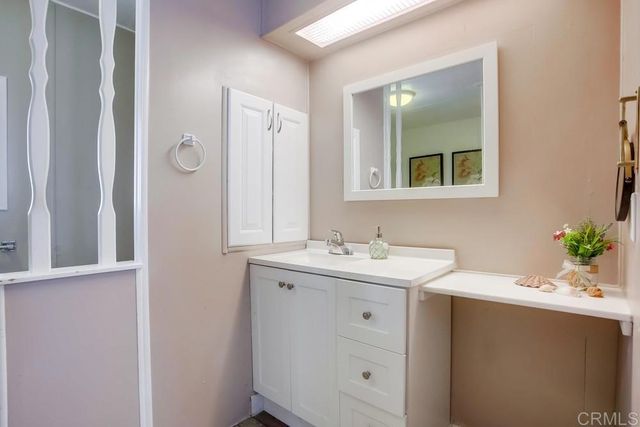 a bathroom with a sink vanity and mirror