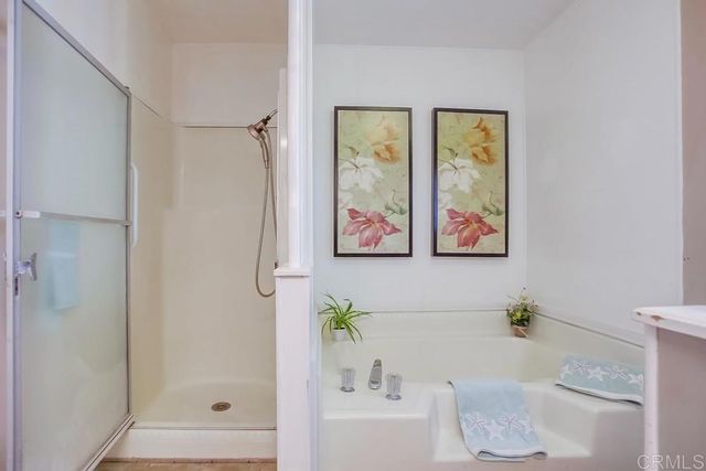 a bath room with a bathtub and a shower