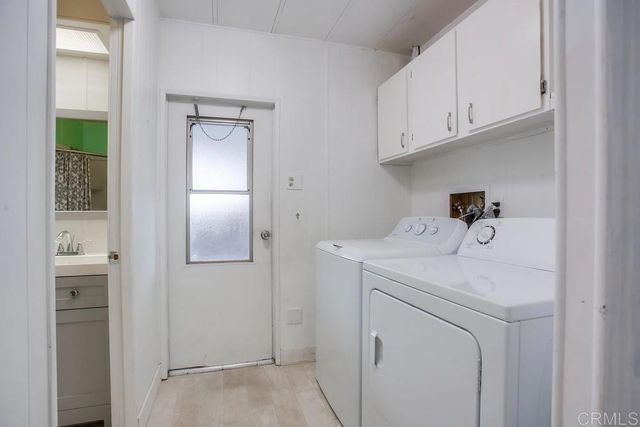 a utility room with closet dryer and washer