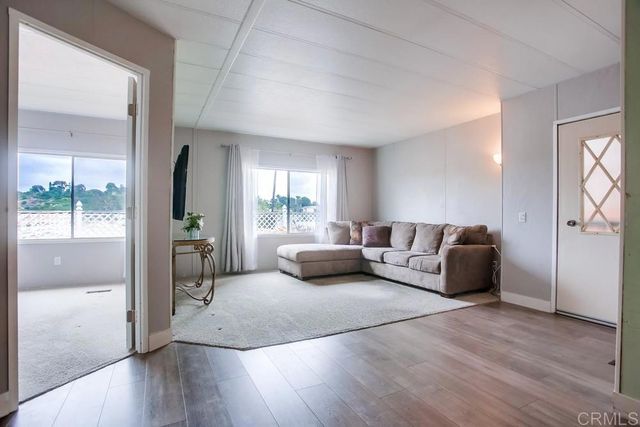 a bedroom with furniture and a wooden floor