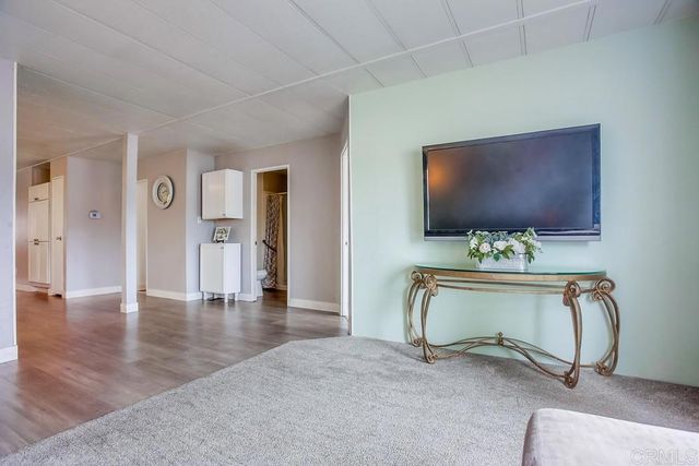 a view of a livingroom with furniture and a flat screen tv