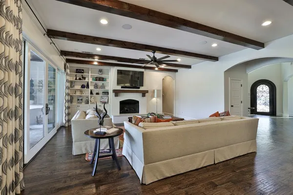 a living room with furniture a fireplace and a potted plant
