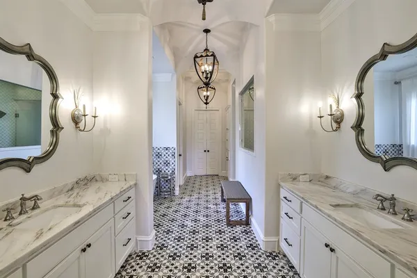 a spacious bathroom with a double vanity sink mirror and toilet