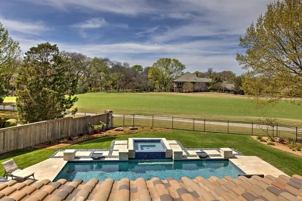 a view of a lake with couches in the patio