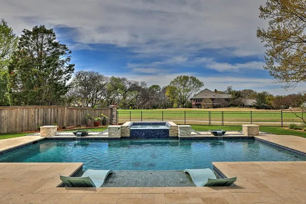 swimming pool view with a seating space