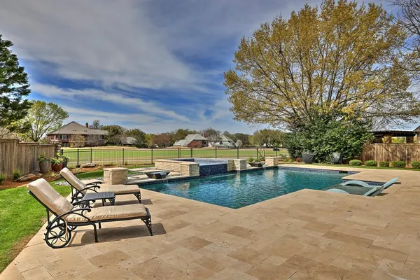 a view of swimming pool with outdoor seating and plants