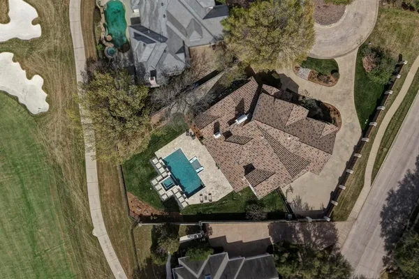 an aerial view of a house with table and chairs