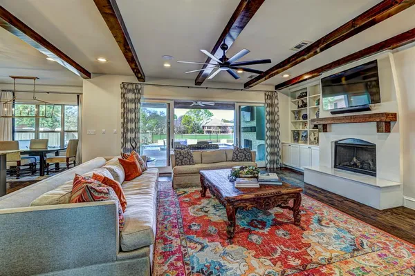 a living room with furniture a fireplace and a flat screen tv
