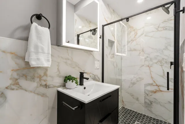 a bedroom with a bed wooden floor and window