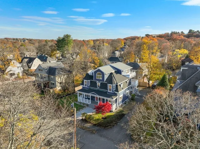 an aerial view of a houses with a yard