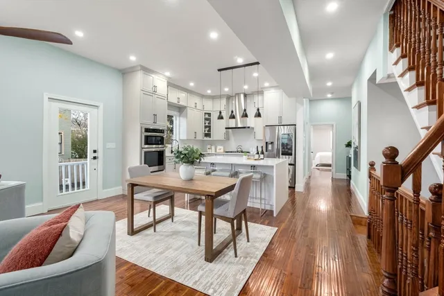 a large kitchen with a table and chairs