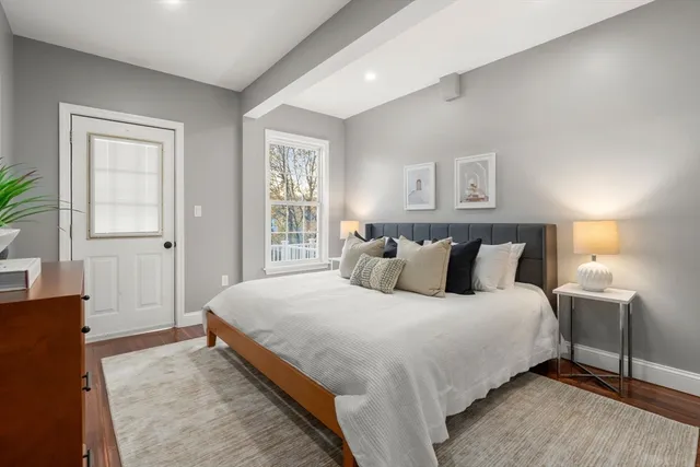 a bathroom with a sink a toilet and a window