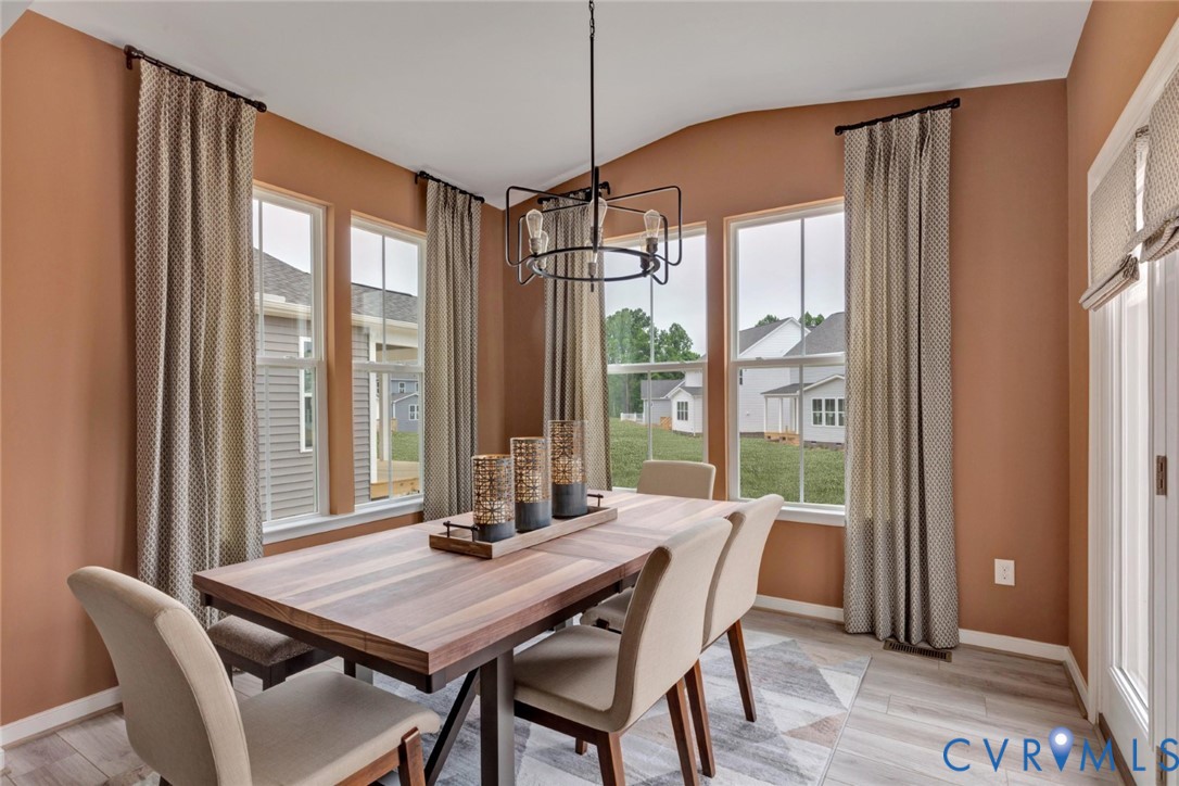 925 Charlemagne Road Midlothian, VA 23114 - Photo 14 of 43 a view of a dining room with furniture and windows