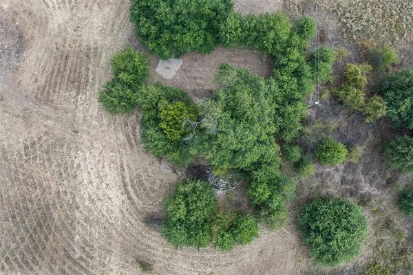 an aerial view of a house with a yard