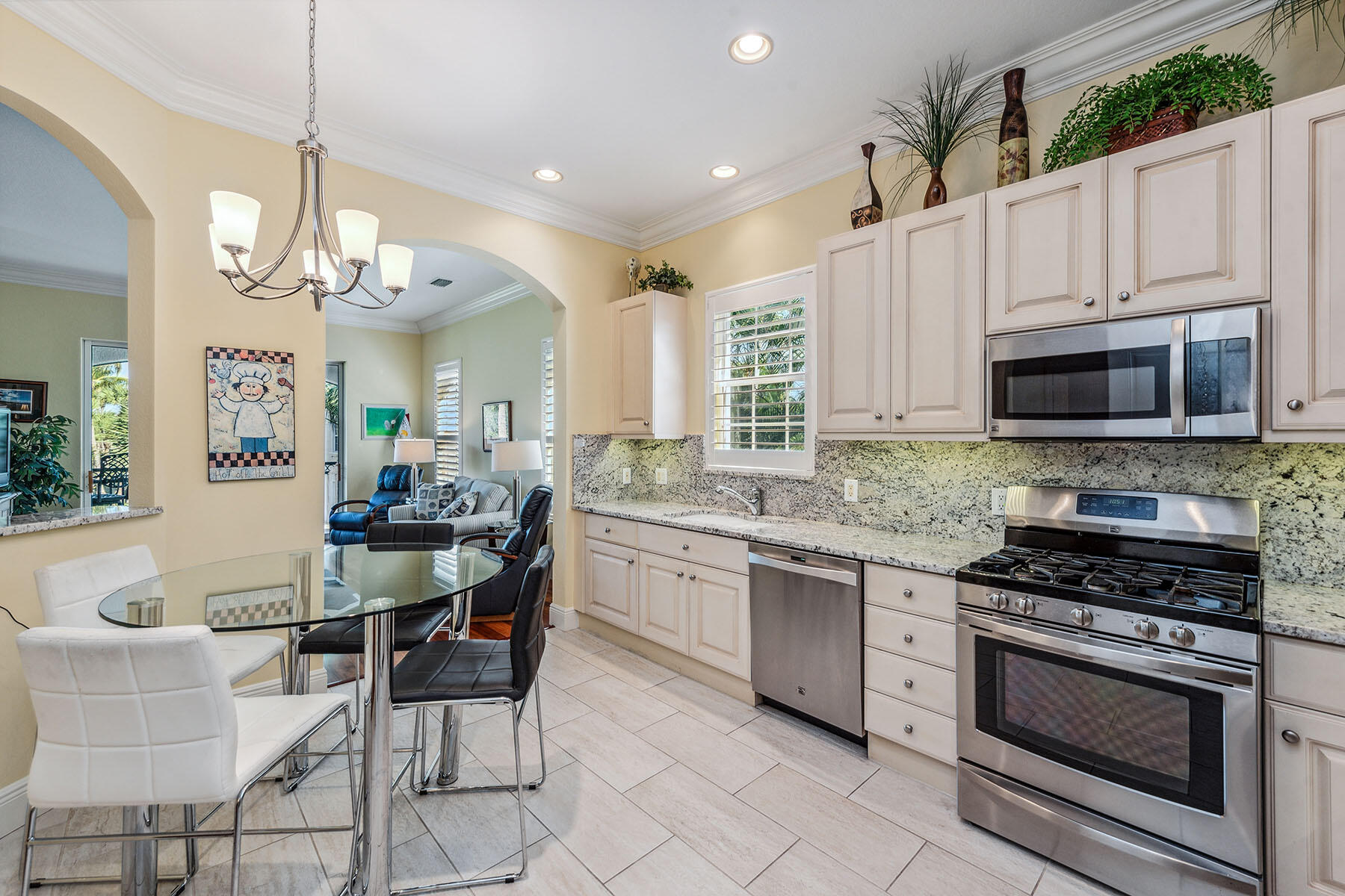3189 Aviamar Circle, Unit 202 Naples, FL 34114 - Photo 10 of 50 a kitchen with stainless steel appliances granite countertop a stove a sink and a refrigerator