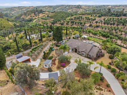 a picture of a houses with a yard and garden
