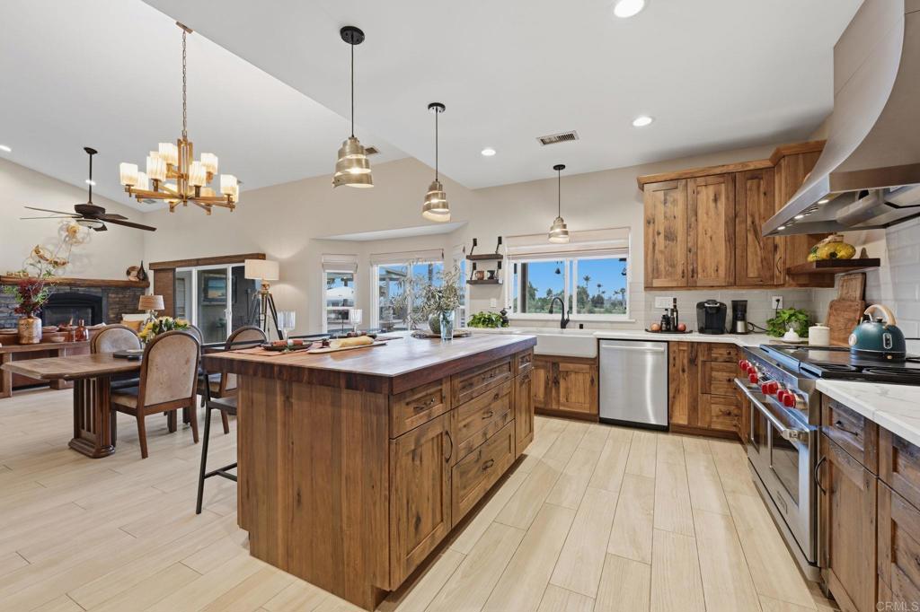 1655 Colina Vista Fallbrook, CA 92028 - Photo 13 of 63 a kitchen with stainless steel appliances granite countertop a sink a stove top oven a counter space and cabinets