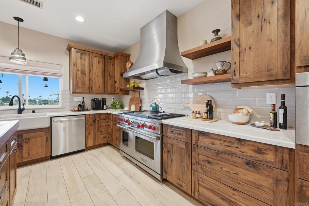 1655 Colina Vista Fallbrook, CA 92028 - Photo 14 of 63 a kitchen with stainless steel appliances granite countertop a sink and cabinets