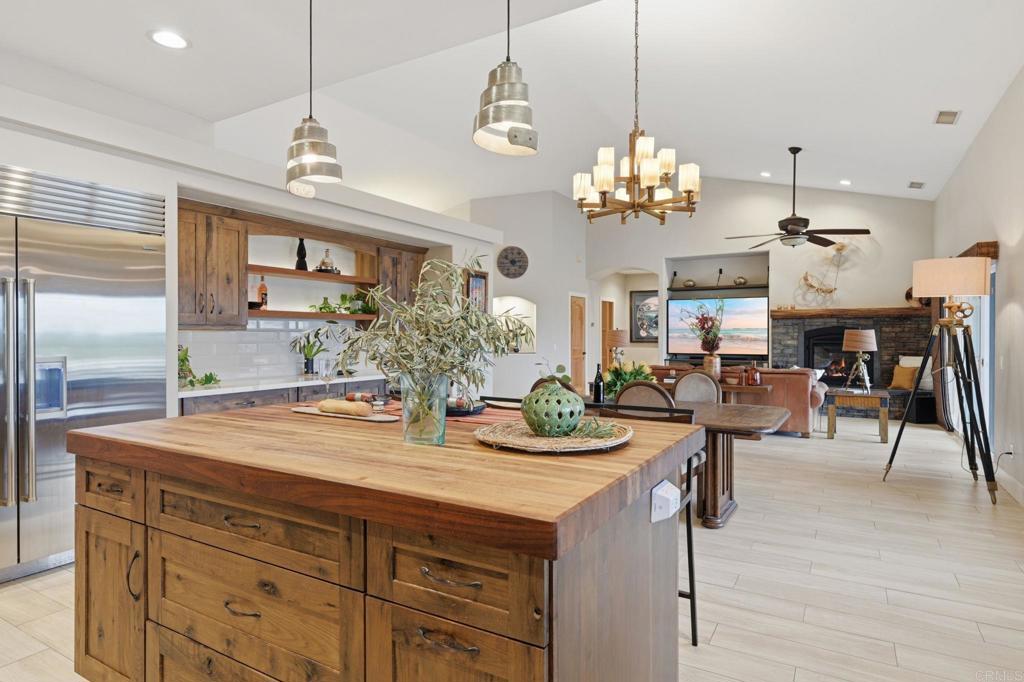 1655 Colina Vista Fallbrook, CA 92028 - Photo 16 of 63 a view of a dining room with furniture a chandelier and wooden floor