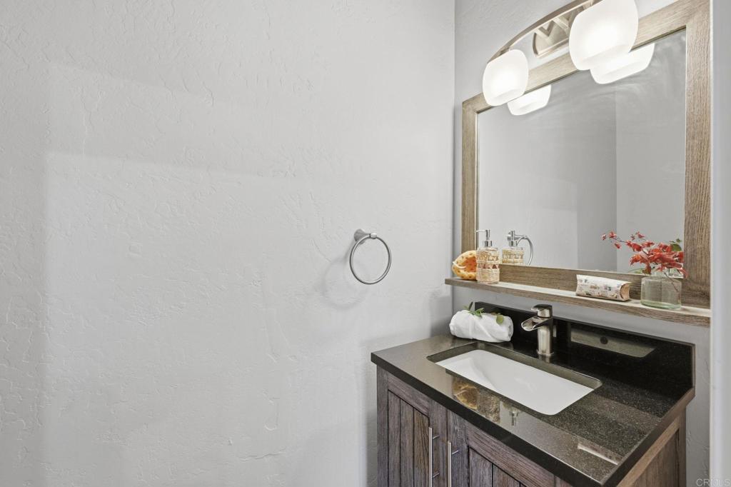 1655 Colina Vista Fallbrook, CA 92028 - Photo 30 of 63 a bathroom with a sink and a mirror