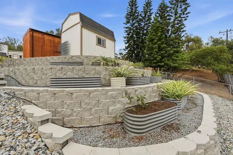 an aerial view of a house with swimming pool patio and outdoor seating