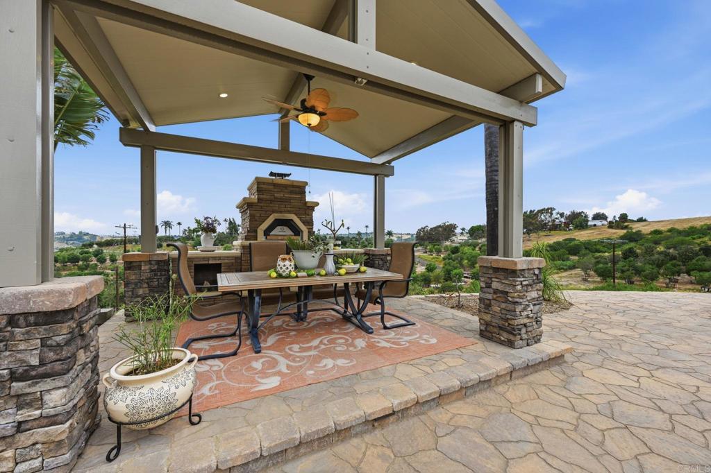 1655 Colina Vista Fallbrook, CA 92028 - Photo 54 of 63 a view of a patio with a dining table and chairs with wooden floor and fence