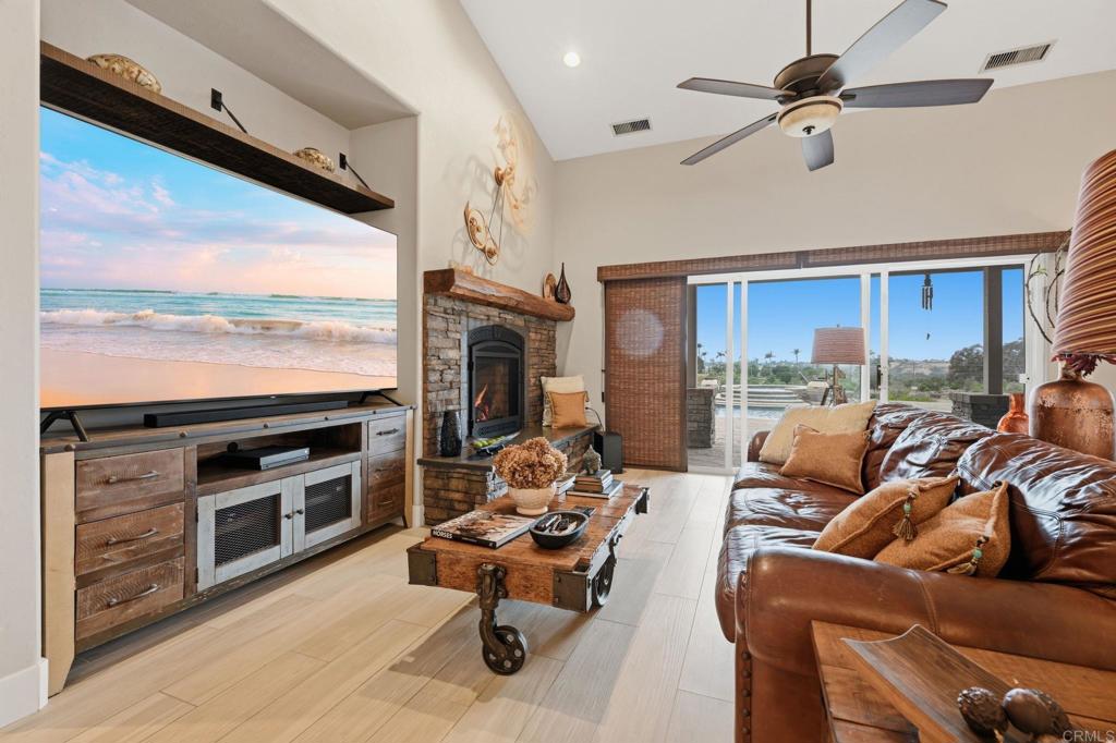 1655 Colina Vista Fallbrook, CA 92028 - Photo 8 of 63 a living room with furniture a fireplace and a flat screen tv