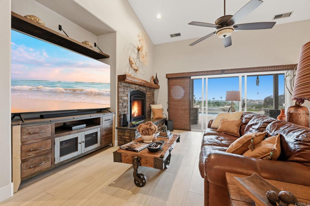 1655 Colina Vista Fallbrook, CA 92028 - Photo 9 of 63 a living room with furniture a fireplace and a flat screen tv