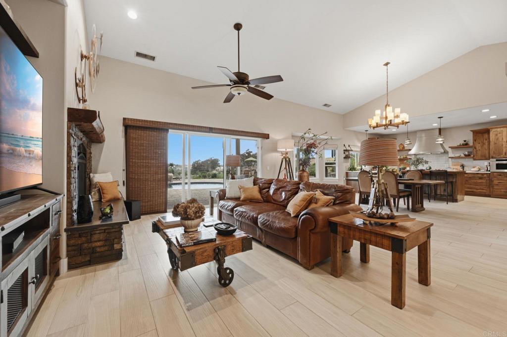 1655 Colina Vista Fallbrook, CA 92028 - Photo 10 of 63 a living room with furniture a chandelier and a flat screen tv
