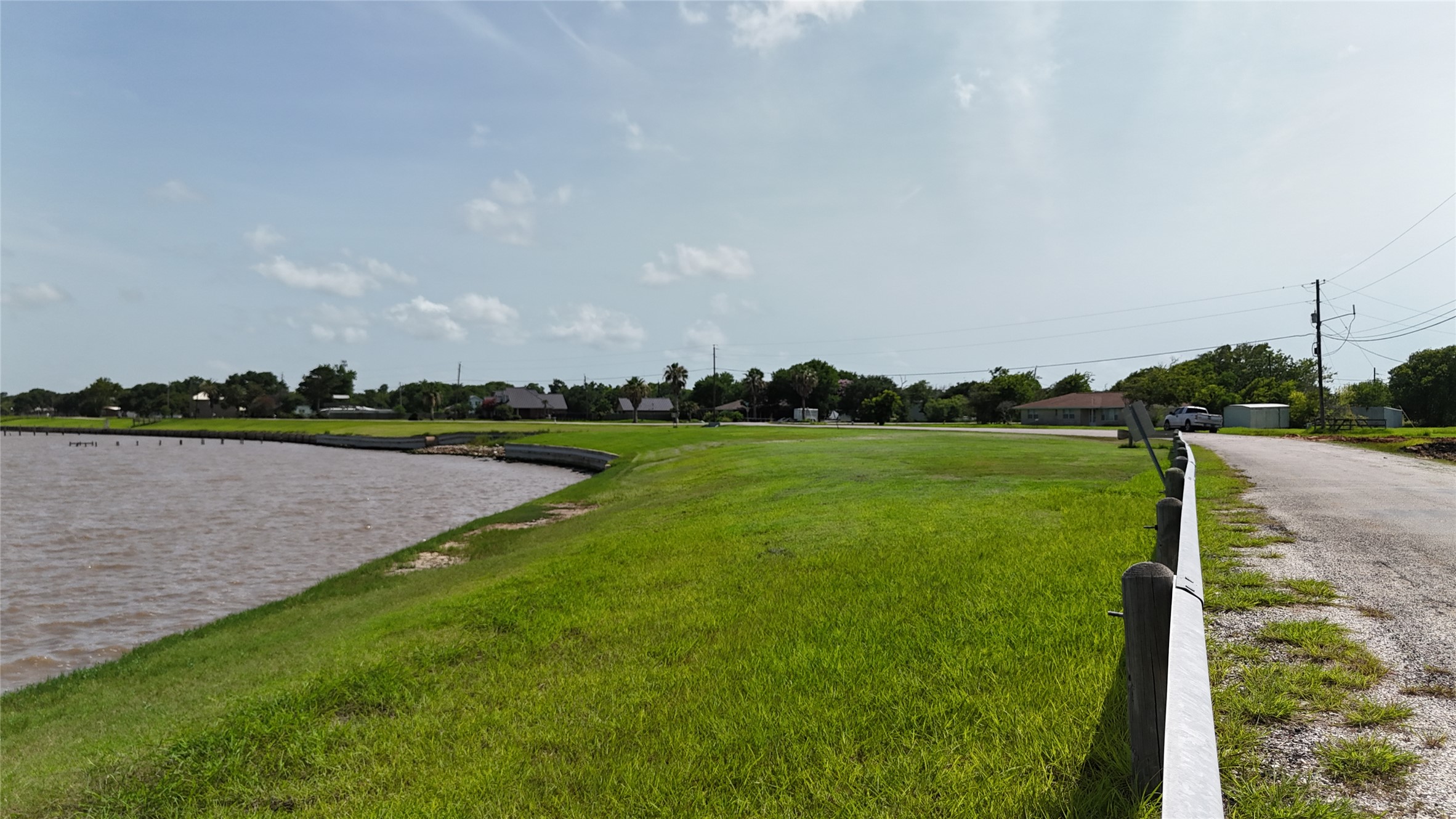 305 Bayshore Road Palacios, TX 77465 - Photo 4 of 25 Green, open lot with waterfront access and clear skies presents an exceptional building opportunity.