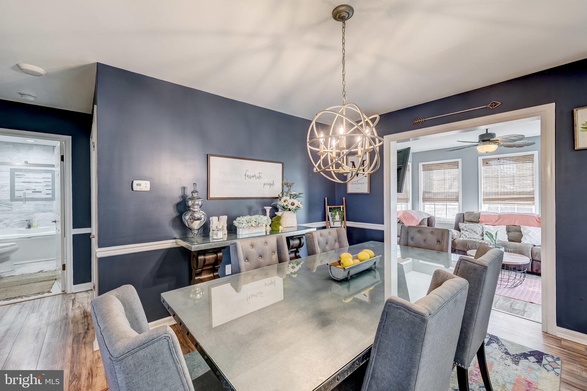 31275 East Line Road Delmar, MD 21875 - Photo 8 of 41 a view of a dining room with furniture a chandelier and wooden floor