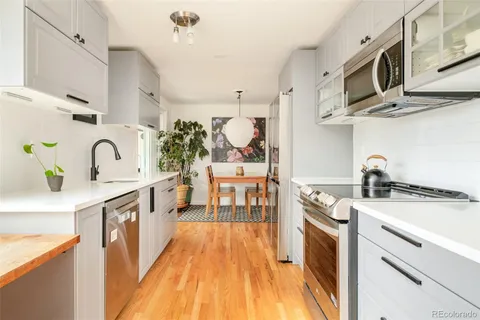 a kitchen with stainless steel appliances granite countertop a sink and cabinets