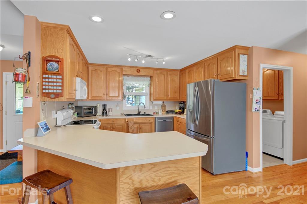 3520 Mack Ballard Road Maiden, NC 28650 - Photo 13 of 25 a kitchen with refrigerator a stove a sink and cabinets