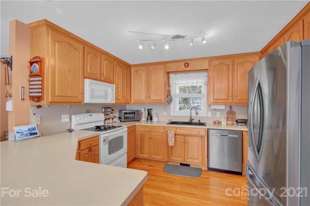 3520 Mack Ballard Road Maiden, NC 28650 - Photo 14 of 25 a kitchen with a sink a refrigerator and cabinets