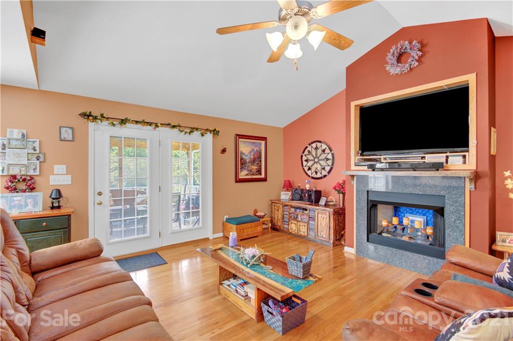 3520 Mack Ballard Road Maiden, NC 28650 - Photo 17 of 25 a living room with furniture a flat screen tv and a fireplace